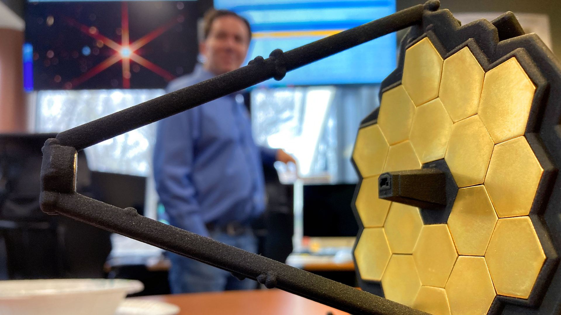 Telescope manager Lee Feinberg is framed by a small model of the James Webb Space Telescope at the Space Telescope Science Institute at the Johns Hopkins University in March.