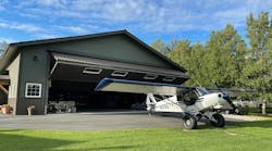 The 50-foot-by-50-foot hangar (shown here) is equipped with a Schweiss Doors bifold lift-strap door, complete with remote opener and automatic latching system.