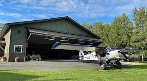 The 50-foot-by-50-foot hangar (shown here) is equipped with a Schweiss Doors bifold lift-strap door, complete with remote opener and automatic latching system.