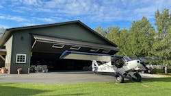 The 50-foot-by-50-foot hangar (shown here) is equipped with a Schweiss Doors bifold lift-strap door, complete with remote opener and automatic latching system. The 50-foot-by-50-foot hangar (shown here) is equipped with a Schweiss Doors bifold lift-strap door, complete with remote opener and automatic latching system.