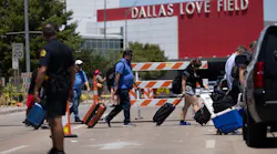 Travelers leave as Dallas police investigate reports of a shooting at Dallas Love Field airport on Monday, July 25, 2022, in Dallas, TX. A ground stop was issued at Love Field airport Monday morning after a woman fired several shots inside the terminal, Dallas police said.