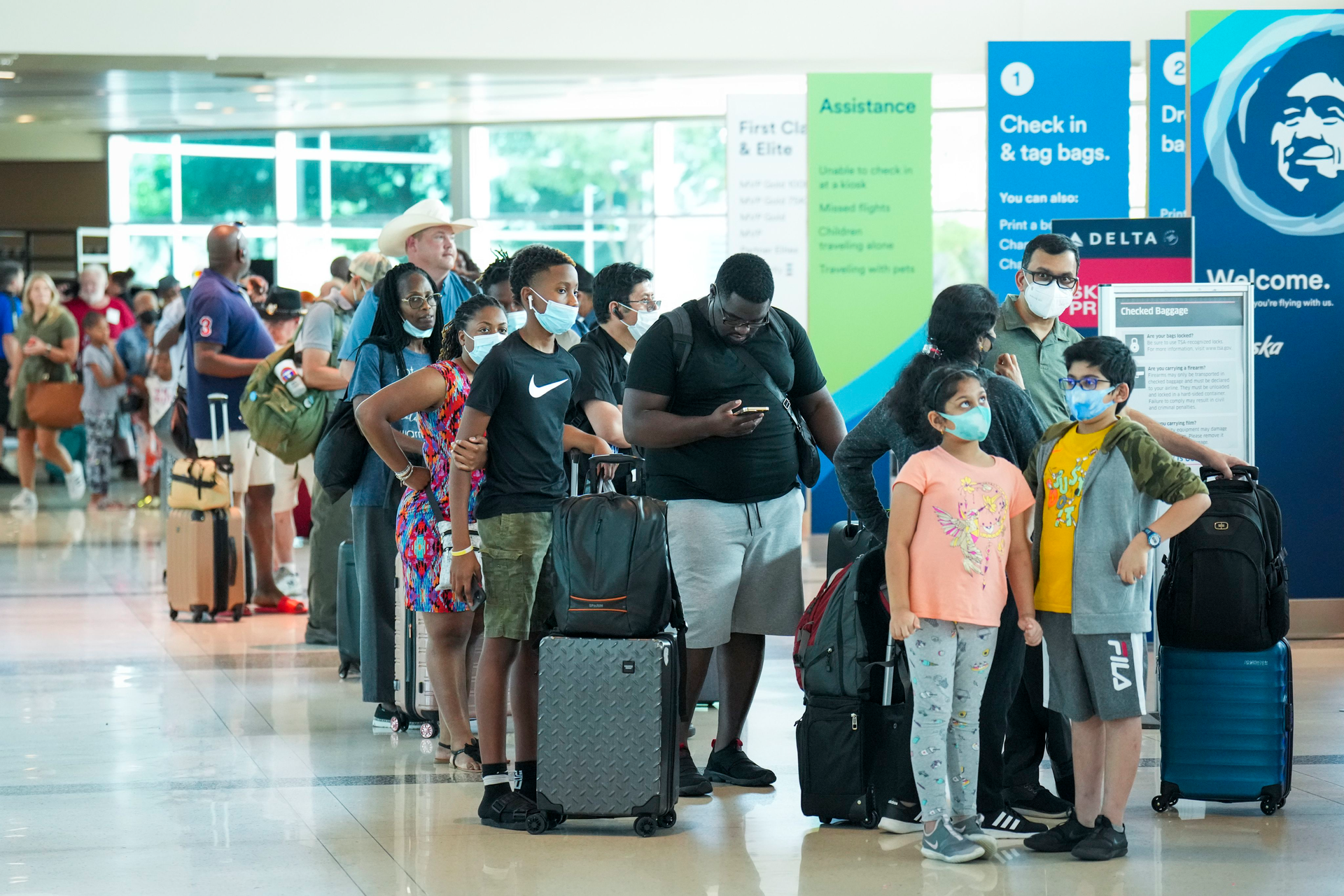 Passengers in line to check in for a flight at Dallas Love Field Airport on Monday, July 25, 2022. A ground stop was ordered for flights at Love Field airport after Dallas police shot a woman who fired several shots inside the terminal, police said, with flights resuming hours later.