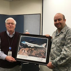 Al Stuart shows a presentation made to him by the crew of Air Force One in recognition of SLC Airport Operation&rsquo;s support.