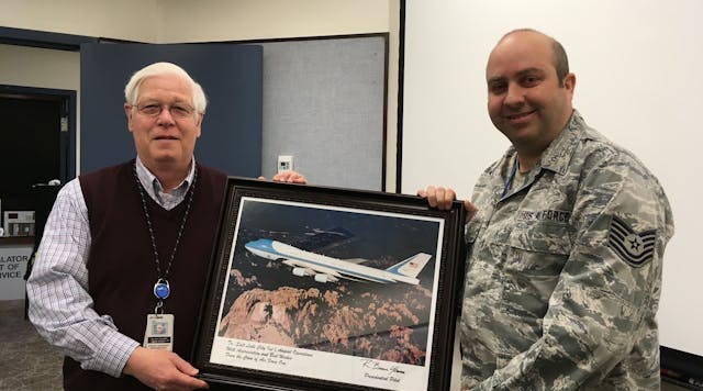Al Stuart shows a presentation made to him by the crew of Air Force One in recognition of SLC Airport Operation&rsquo;s support.