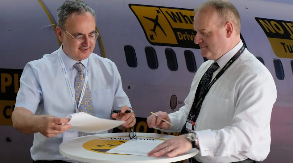 AlbaStar CEO Michael Harrington and WheelTug CEO Isaiah Cox signing the agreement.