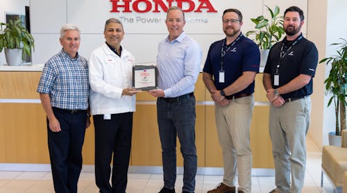 Ryan McCartney (third from the left), vice president and COO, Hillsboro Aviation, receives the Authorized Service Center plaque from Amod Kelkar (second from the left), head of the commercial business unit and vice president, customer service for Honda Aircraft Company.