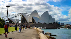 People walk along the waterfront of Sydney Harbor in Sydney, Australia, on Feb. 26, 2017. In the background is the iconic Sydney Opera House.