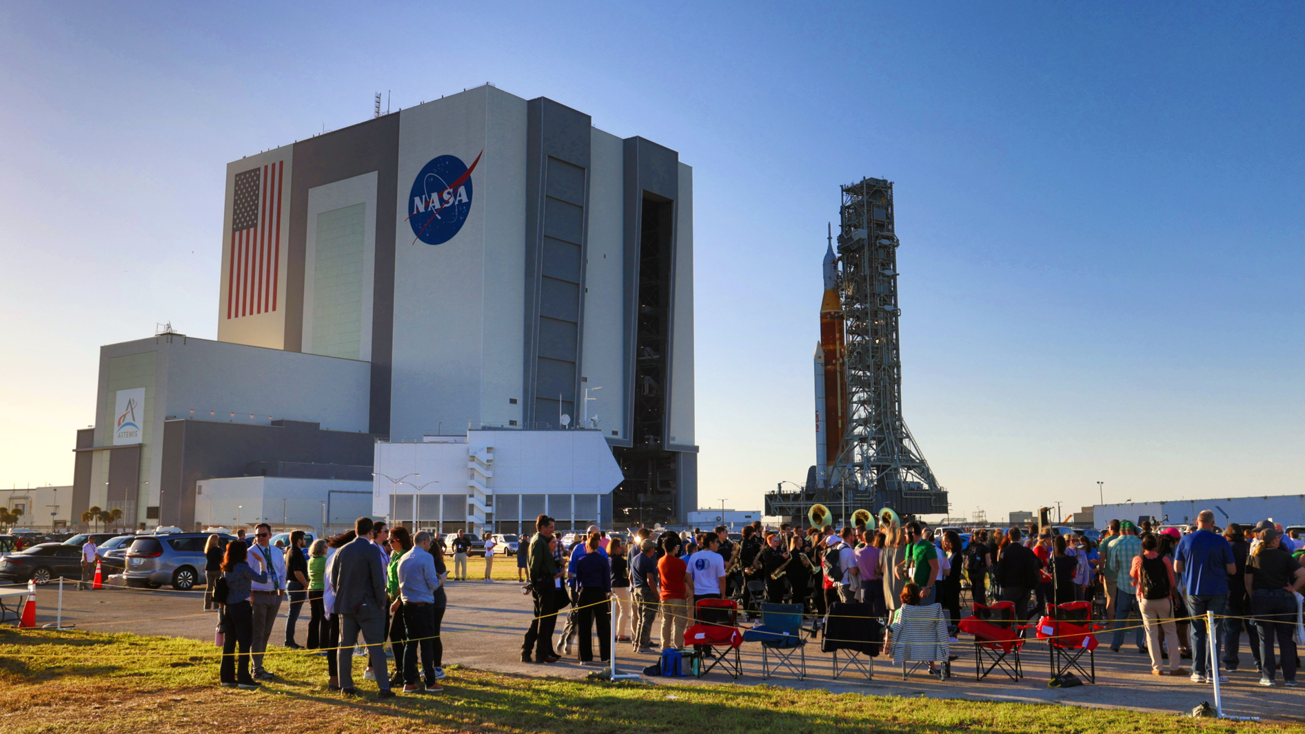 At Kennedy Space Center, Fla., VIPs watch NASA s moon rocket for the Artemis 1 mission roll to the launch pad, Thursday, March 17, 2022. Known as the Space Launch System (SLS), the mega-rocket carrying the Orion spacecraft capsule rollouts for the first time Thursday evening on the giant crawler-transporter 2, headed to Launch Complex 39-B.