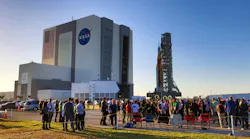 At Kennedy Space Center, Fla., VIPs watch NASA s moon rocket for the Artemis 1 mission roll to the launch pad, Thursday, March 17, 2022. Known as the Space Launch System (SLS), the mega-rocket carrying the Orion spacecraft capsule rollouts for the first time Thursday evening on the giant crawler-transporter 2, headed to Launch Complex 39-B.