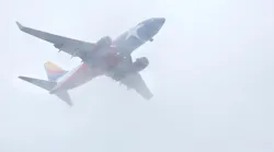 A Texas flag themed Southwest Airlines jet cuts through the low cloud bank in downtown Dallas as it makes it's approach to Love Field, Tuesday afternoon, October 16, 2018. Waves of rain are expected the rest of the week.