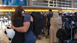 LOS ANGELES, CA - NOVEMBER 28: Paloma Camacho, 21, hugs at Anthony Long, 22, before her flight at Tom Bradley International Terminal on Sunday, Nov. 28, 2021 in Los Angeles, CA. Sunday after Thanksgiving is one of the busiest days of the year at LAX.