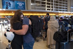 LOS ANGELES, CA - NOVEMBER 28: Paloma Camacho, 21, hugs at Anthony Long, 22, before her flight at Tom Bradley International Terminal on Sunday, Nov. 28, 2021 in Los Angeles, CA. Sunday after Thanksgiving is one of the busiest days of the year at LAX. LOS ANGELES, CA - NOVEMBER 28: Paloma Camacho, 21, hugs at Anthony Long, 22, before her flight at Tom Bradley International Terminal on Sunday, Nov. 28, 2021 in Los Angeles, CA. Sunday after Thanksgiving is one of the busiest days of the year at LAX.