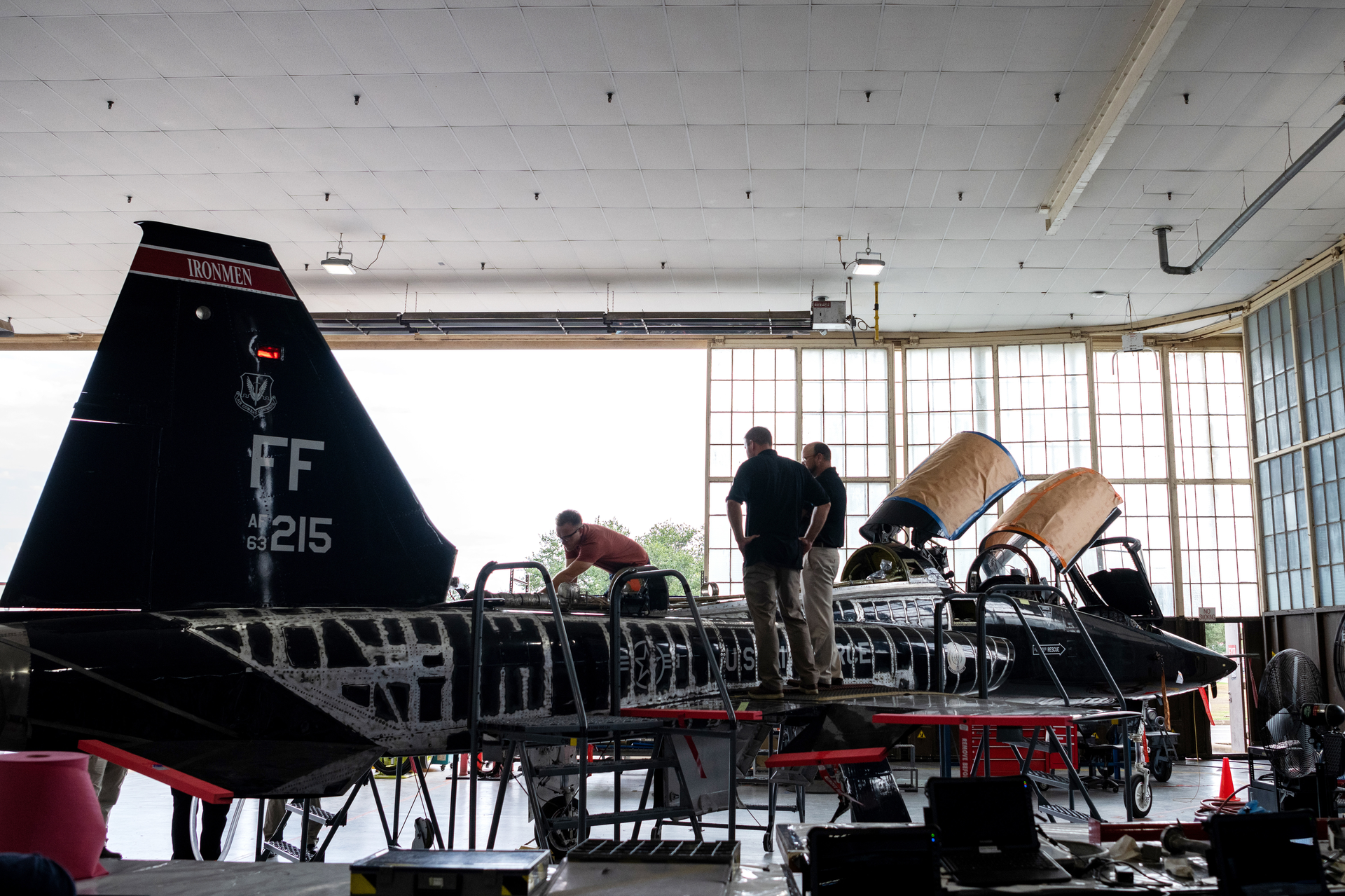 Zach Burleson (left), 809th Aircraft Maintenance Squadron, non-destructive inspection technician, works on a T-38 as part of the Talon Repair Inspections and Maintenance program as Larry Hall (center), 809AMXS, and Robert Pilarczyk (right), Hill Engineering, observe, Aug. 24, 2022, at Joint Base San Antonio-Randolph, Texas. TRIM modification is localized, depot-level maintenance to replace or repair key parts to keep the T-38 training platforms mission ready.