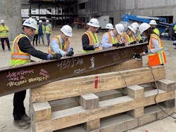Signing the last structural station steel beam prior to it being hoisted into place. Signing the last structural station steel beam prior to it being hoisted into place.