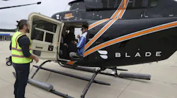 Passengers are loaded into a helicopter during a test flight to simulate an electric flying taxi at Vertiport Chicago on Sept. 13, 2022.