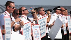 Southwest Airlines pilots drink water while picketing for better work conditions on June 21, 2022, outside Dallas Love Field. Southwest Airlines pilots drink water while picketing for better work conditions on June 21, 2022, outside Dallas Love Field.