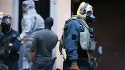 Picture taken on June 12, 2018, shows police officers of a special unit wearing protective clothes and respiratory masks during an operation in Cologne's Chorweiler district, western Germany, where police found toxic substances after storming a flat. - A Tunisian man arrested in Germany is suspected of trying to build a biological weapon using the deadly poison ricin, prosecutors said ... Picture taken on June 12, 2018, shows police officers of a special unit wearing protective clothes and respiratory masks during an operation in Cologne's Chorweiler district, western Germany, where police found toxic substances after storming a flat. - A Tunisian man arrested in Germany is suspected of trying to build a biological weapon using the deadly poison ricin, prosecutors said ...
