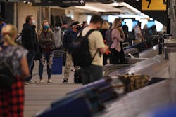 Travelers wait for their bags in the baggage claims at Denver International Airport in on Nov. 20, 2020. Travelers wait for their bags in the baggage claims at Denver International Airport in on Nov. 20, 2020.