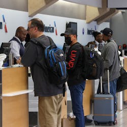 Travelers check in for their flights at Dallas/Fort Worth International Airport.