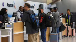 Travelers check in for their flights at Dallas/Fort Worth International Airport.