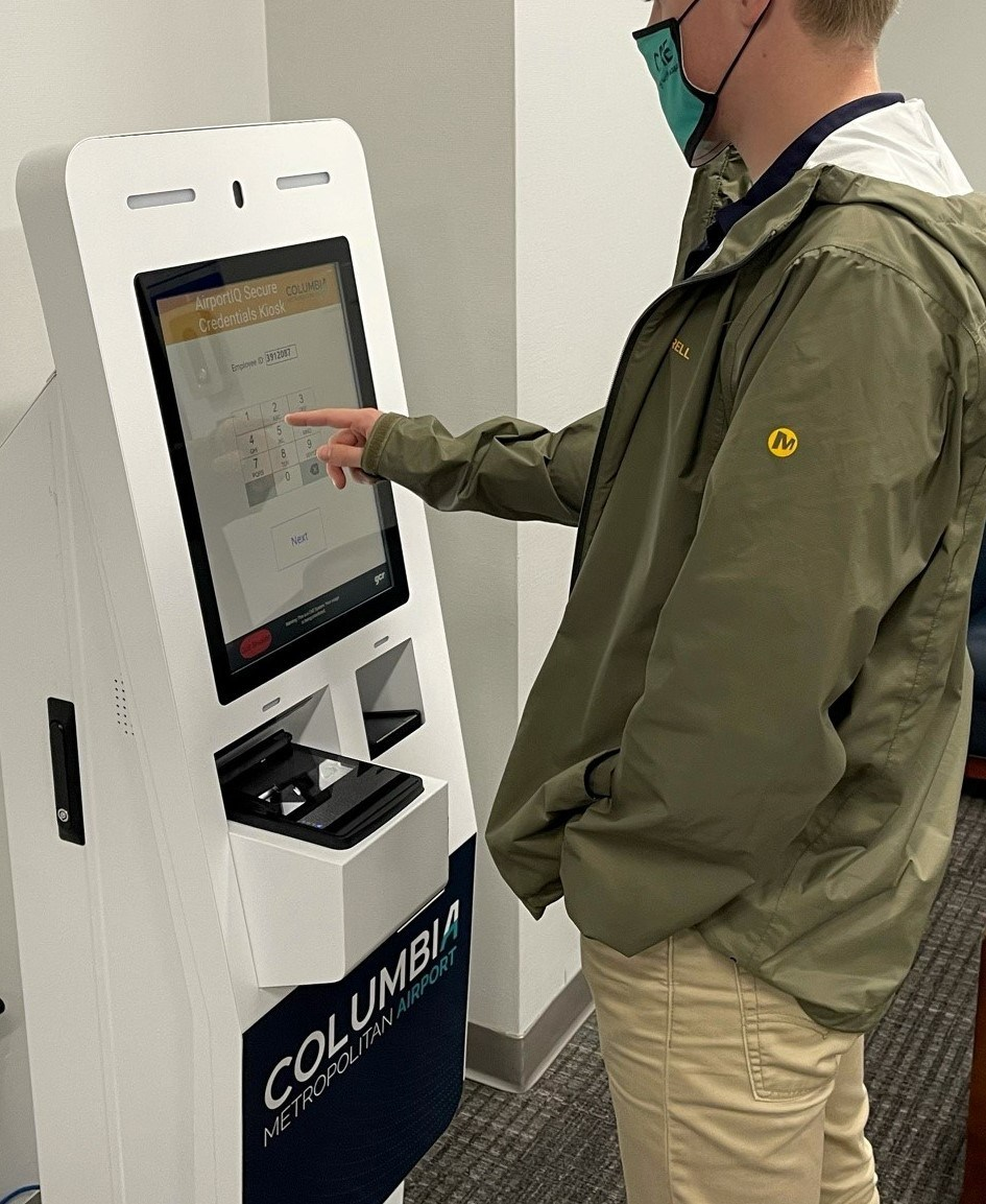 CAE employee using a Civix Secure Credentials Express kiosk.