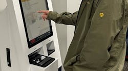 CAE employee using a Civix Secure Credentials Express kiosk.