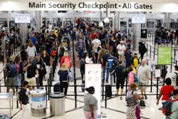 People walk between lines at the Domestic Terminal main security checkpoint entrance at the Hartsfield-Jackson International Airport on Thursday, May 26, 2022.