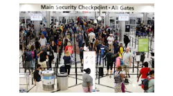 People walk between lines at the Domestic Terminal main security checkpoint entrance at the Hartsfield-Jackson International Airport on Thursday, May 26, 2022.