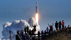 The crowd cheers at Playalinda Beach in the Canaveral National Seashore, just north of the Kennedy Space Center, during the launch of the SpaceX Falcon Heavy rocket, Tuesday, Feb. 6, 2018. Playalinda is one of closest public viewing spots to see the launch, about 3 miles from the SpaceX launchpad 39-A.