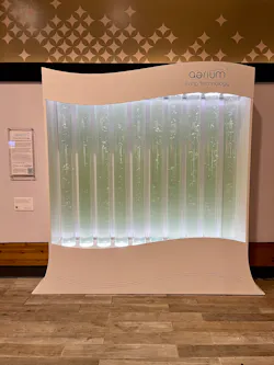 AlgenAir’s aerium carries the power of 5,000 plants; 8-foot-tall exhibit installed in baggage claim. AlgenAir’s aerium carries the power of 5,000 plants; 8-foot-tall exhibit installed in baggage claim.