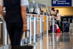 Passengers check their luggage in Terminal D at DFW International Airport in 2020.