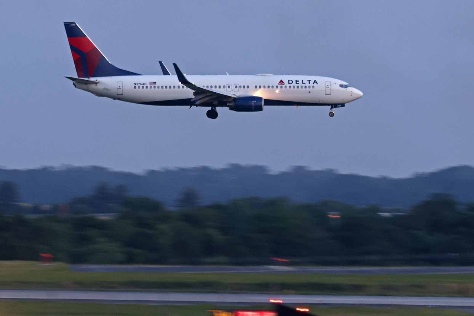 A Delta airplane lands at the Hartsfield-Jackson Atlanta International Airport, Wednesday, June 1, 2022, in Atlanta, Georgia.