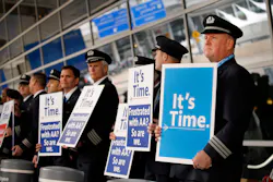 American Airlines first officer Ken Abernathy, right, joins pilots representing the Allied Pilots Association in rallying for a new contract In January 2022 in Dallas.
