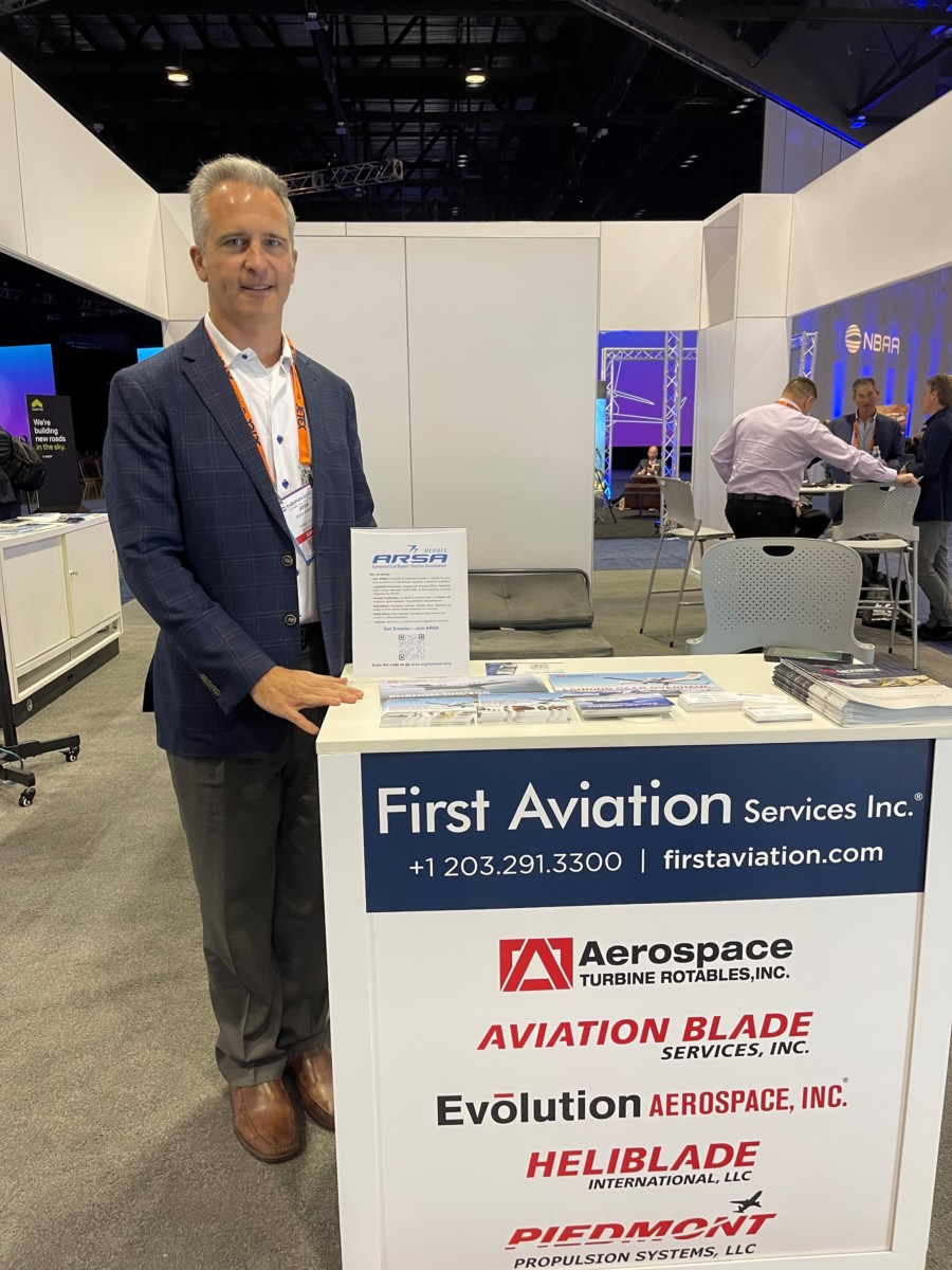 2023 ARSA President Josh Krotec at First Aviation&rsquo;s booth at NBAA-BACE in Orlando, Florida, in October. Krotec is standing next to his &ldquo;ARSA Champion&rdquo; display.