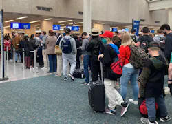 Travelers wait in security check lines at Orlando International Airport. Travelers wait in security check lines at Orlando International Airport.