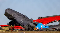 A damaged plane remains in the open field at the Dallas Executive Airport on Sunday, Nov. 13, 2022, after a Boeing B-17 Flying Fortress and a Bell P-63 Kingcobra crash a day earlier.