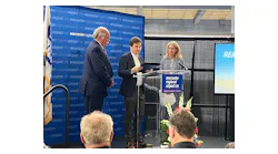 State Reps. Jim O'Day, left, and David LeBoeuf present a citation to Massport CEO Lisa Wieland in honor of Worcester Regional Airport's one millionth passenger.