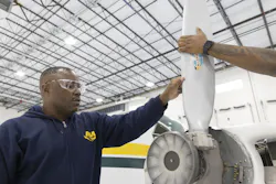 Eric Tsapi, left, works on an aircraft on Oct. 24, 2022, in Chicago. Eric Tsapi, left, works on an aircraft on Oct. 24, 2022, in Chicago.