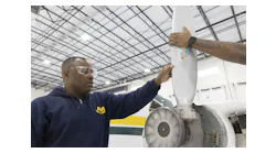 Eric Tsapi, left, works on an aircraft on Oct. 24, 2022, in Chicago.