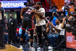 Miami Heat forward Jimmy Butler (22) shakes hands with Odell Beckham Jr. before the first half of an NBA game against the Phoenix Suns at FTX Arena in Downtown Miami, Florida, on Monday, November 14, 2022.
