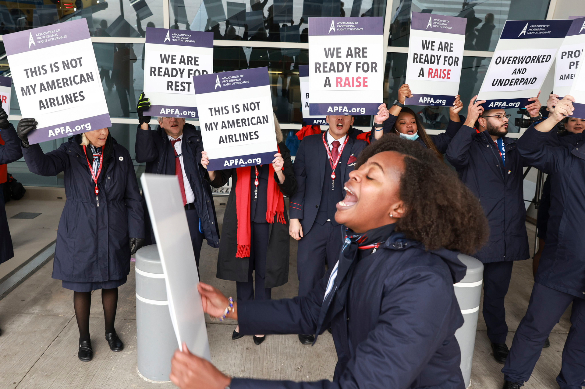 Kaila Gardner cheers to rally other flight attendants during an informational picket Tuesday, Nov. 15, 2022, at Dallas/Fort Worth International Airport.
