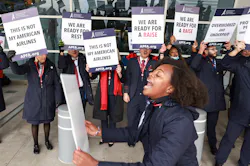 Kaila Gardner cheers to rally other flight attendants during an informational picket Tuesday, Nov. 15, 2022, at Dallas/Fort Worth International Airport.
