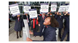 Kaila Gardner cheers to rally other flight attendants during an informational picket Tuesday, Nov. 15, 2022, at Dallas/Fort Worth International Airport.