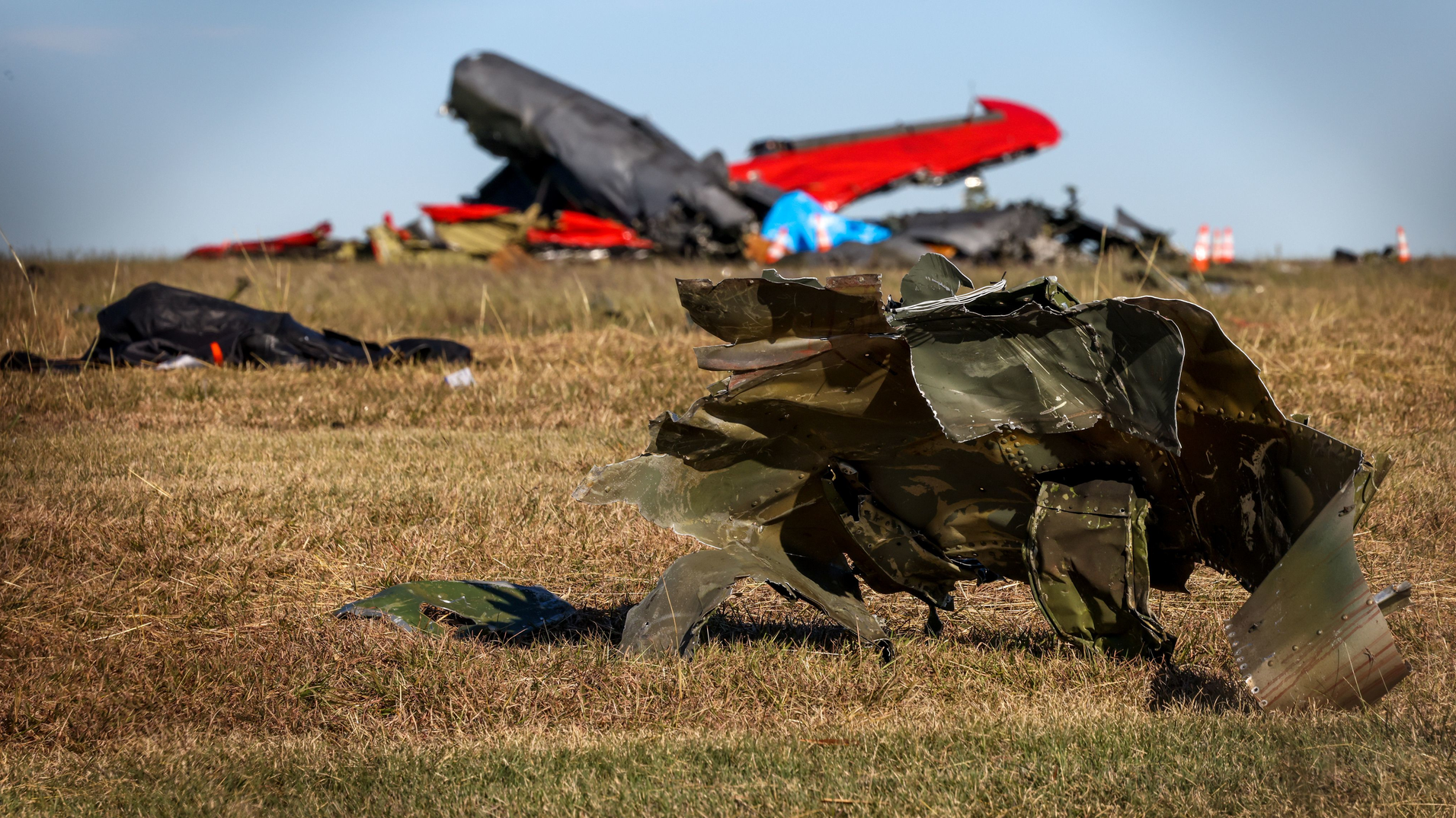 Debris lays across the open field at the Dallas Executive Airport on Nov. 13 after a Boeing B-17 Flying Fortress and a Bell P-63 Kingcobra collided in midair a day earlier.