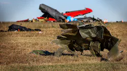 Debris lays across the open field at the Dallas Executive Airport on Nov. 13 after a Boeing B-17 Flying Fortress and a Bell P-63 Kingcobra collided in midair a day earlier.