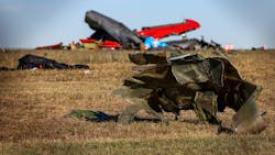 Debris lays across the open field at the Dallas Executive Airport on Nov. 13 after a Boeing B-17 Flying Fortress and a Bell P-63 Kingcobra collided in midair a day earlier. Debris lays across the open field at the Dallas Executive Airport on Nov. 13 after a Boeing B-17 Flying Fortress and a Bell P-63 Kingcobra collided in midair a day earlier.