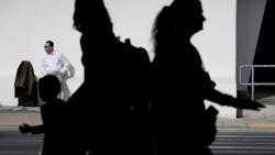 Los Angeles, CA - December 22: A holiday traveler waits for ground transportation at LAX on Thursday, Dec. 22, 2022 in Los Angeles, CA. Los Angeles, CA - December 22: A holiday traveler waits for ground transportation at LAX on Thursday, Dec. 22, 2022 in Los Angeles, CA.