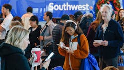 Ketmany Rasasack reads as she waits in line to reach a Southwest Airlines ticket counter at Dallas Love Field Airport on Tuesday. Rasasack s original flight was canceled the day before. Ketmany Rasasack reads as she waits in line to reach a Southwest Airlines ticket counter at Dallas Love Field Airport on Tuesday. Rasasack s original flight was canceled the day before.