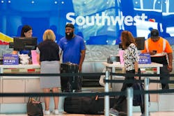 Southwest Airlines ticketing and ramp agents work at a check-in desk at Dallas Love Field in July. Southwest Airlines ticketing and ramp agents work at a check-in desk at Dallas Love Field in July.