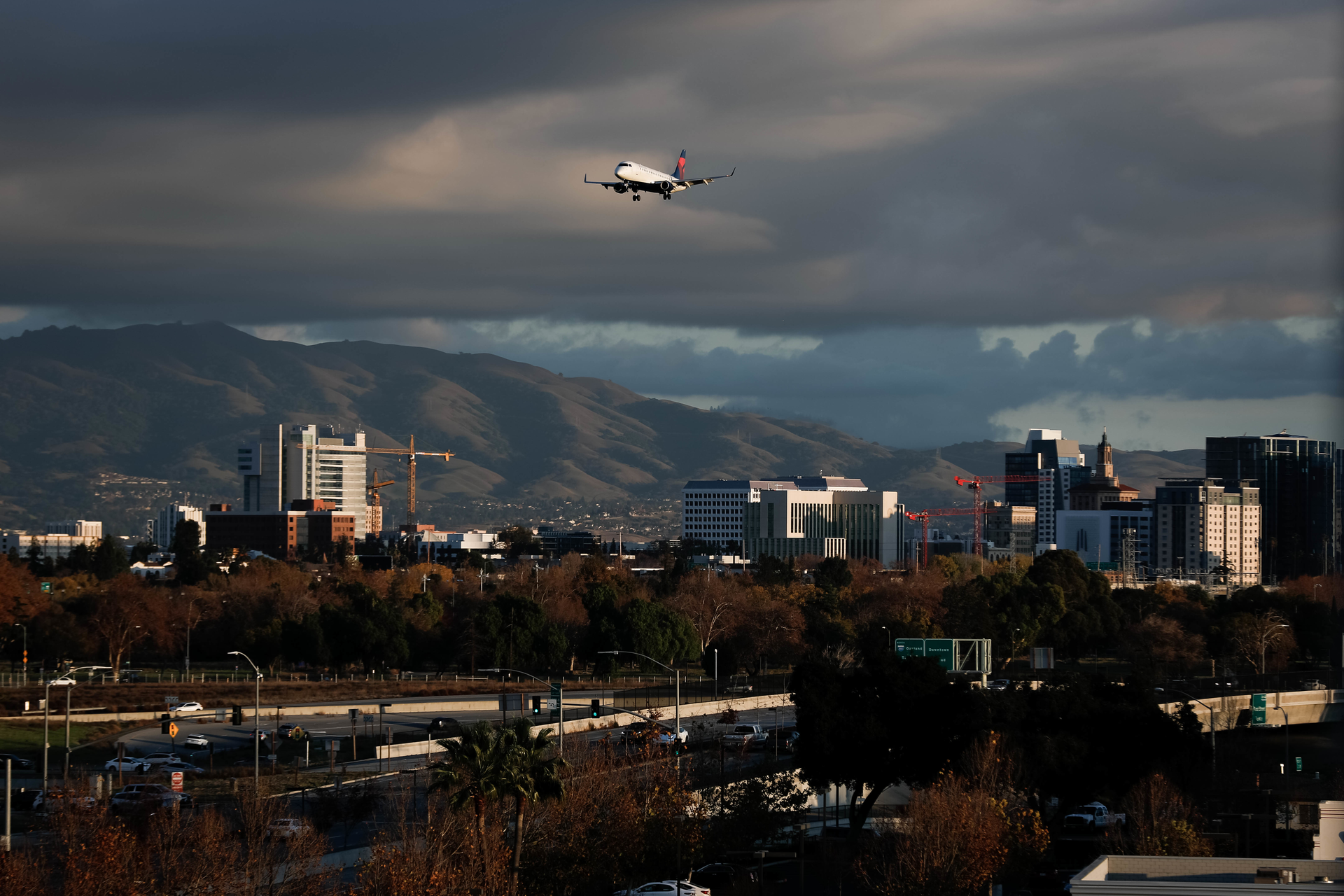 SAN JOSE, CALIFORNIA - DECEMBER 8: An airplane flies over downtown San Jose, Calif., into the the Mineta San Jose Airport on Sunday, Dec. 8, 2019.